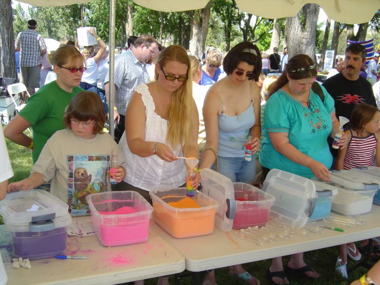 Image of guests creating sand art projects at an event.